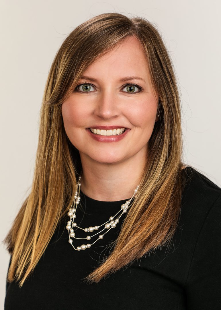 A woman with long hair wearing a black shirt