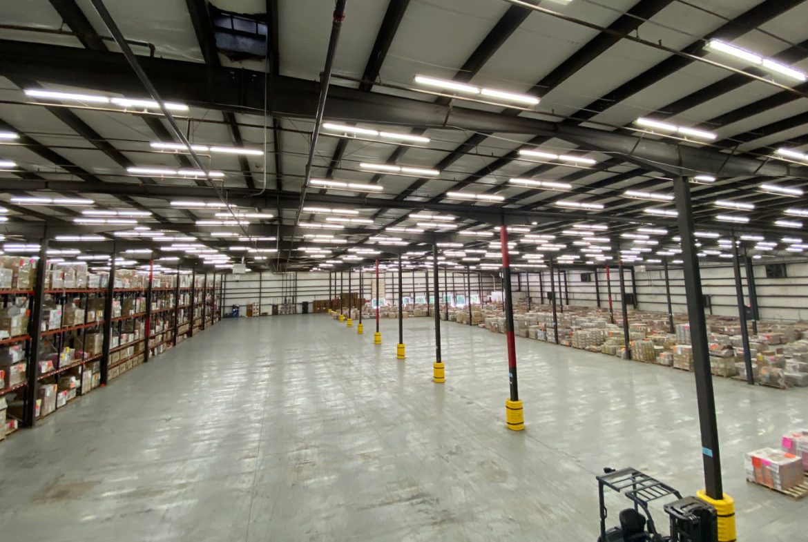 A large warehouse with many rows of shelves.